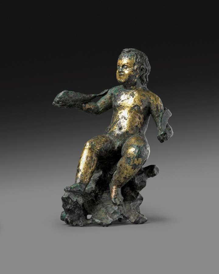 Statuette depicting a rare iconography of the god Eros, sitting on a rock and holding a fish